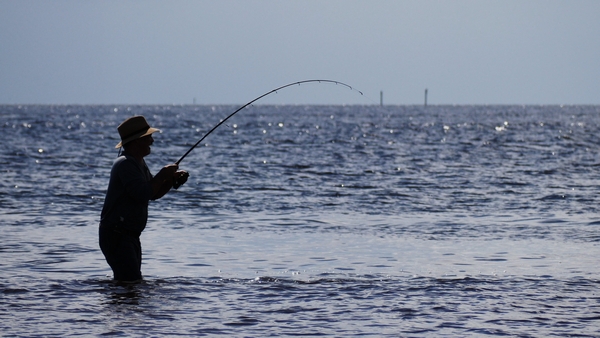 a fisherman showing his catch