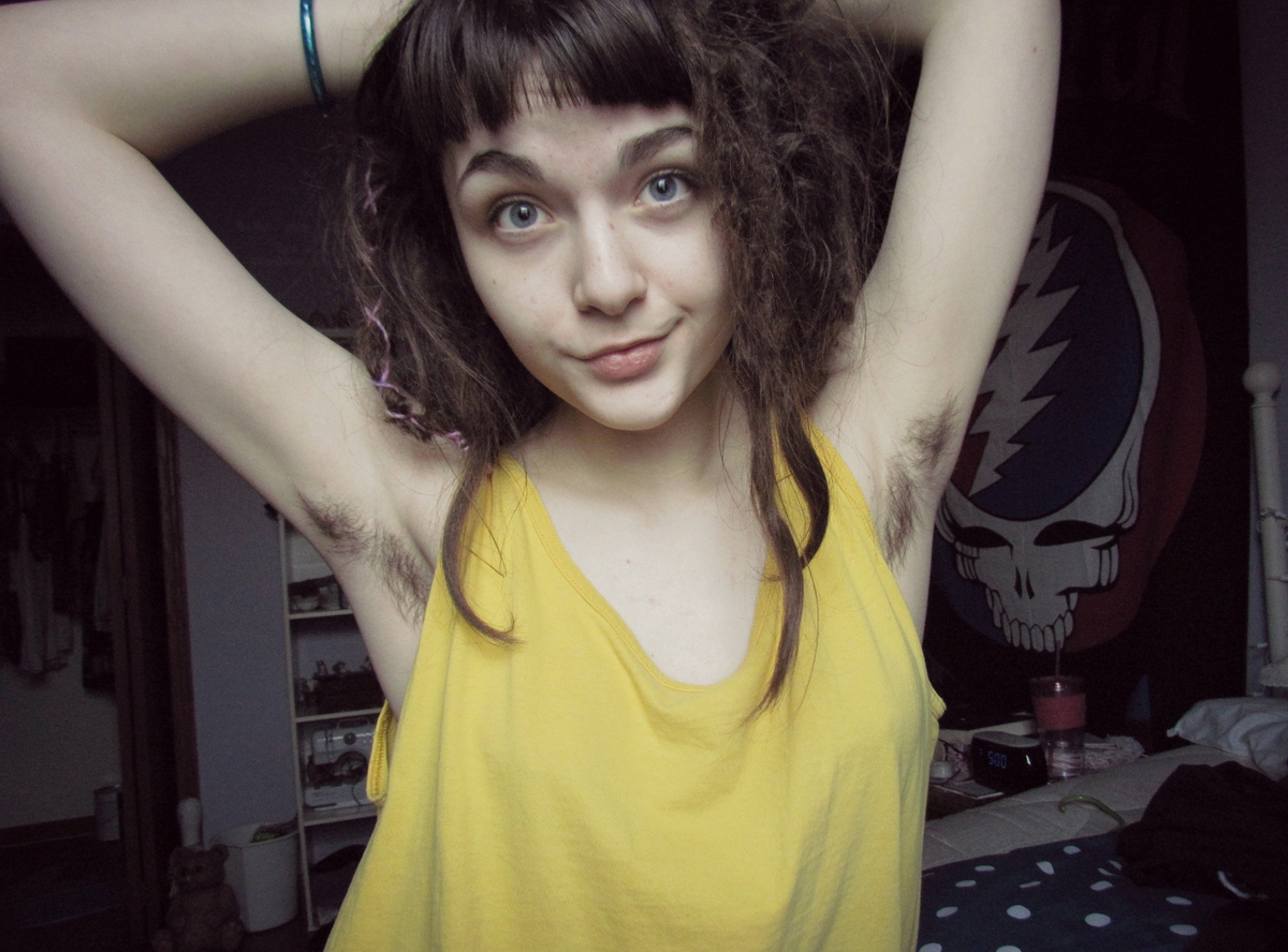 a girl showing her hairy armpits