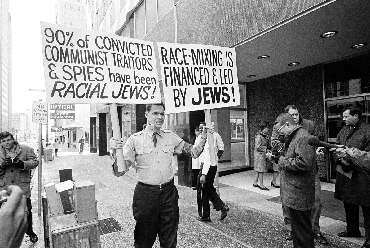 George Lincoln Rockwell holding anti-Jew signs