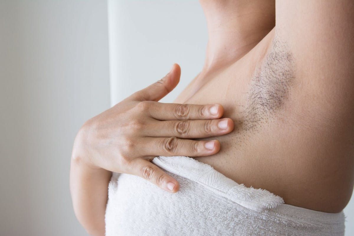 a woman showing her armpit hair