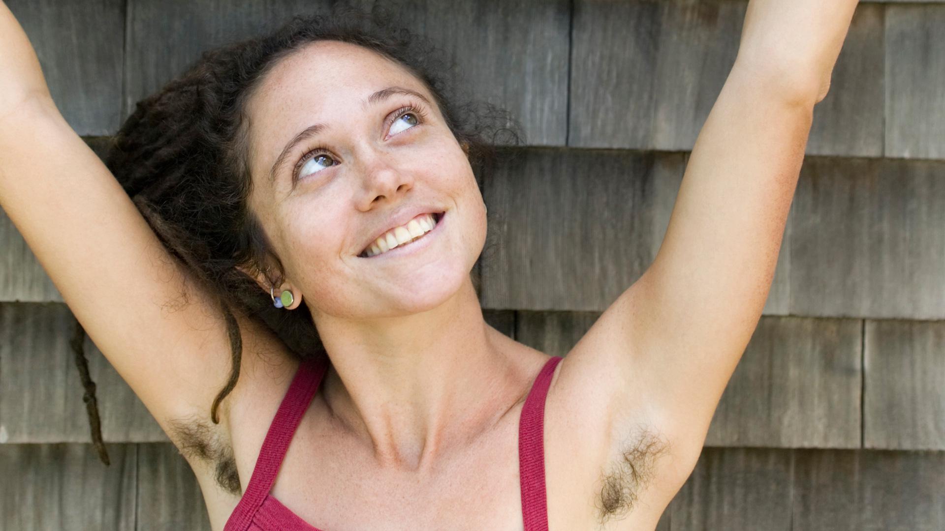 a girl posing and showing her armpit hair