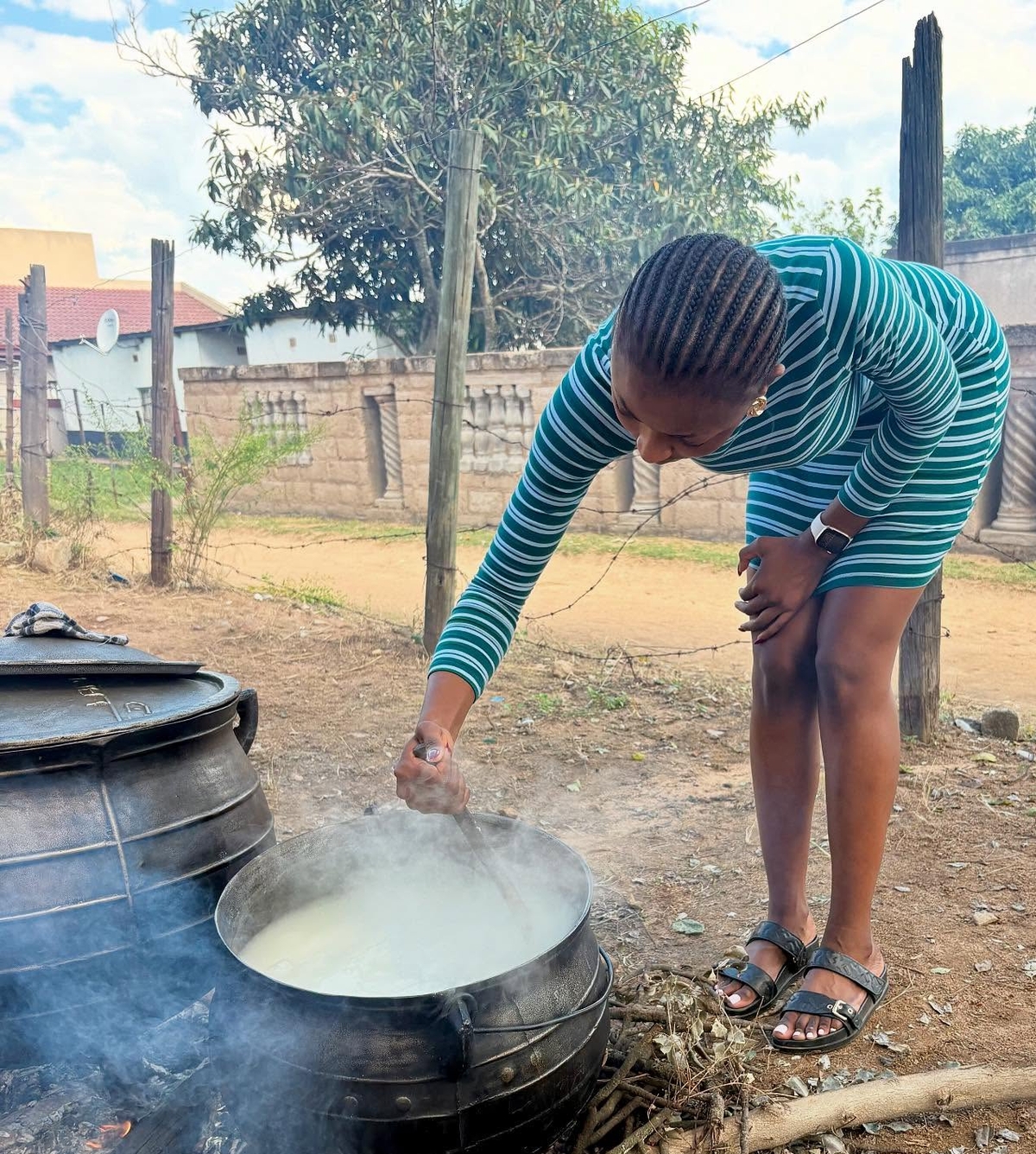 Bajabulise Thela stirring a pot