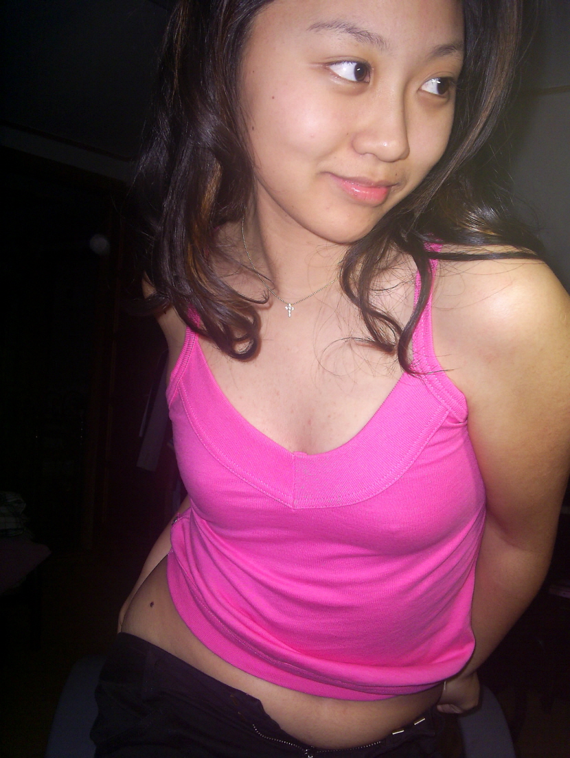 a girl posing in a pink tank top