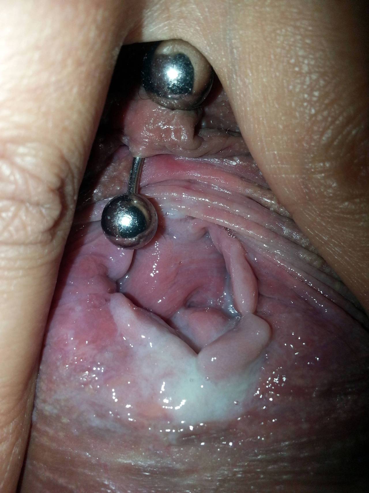 a girl showing her pierced pussy