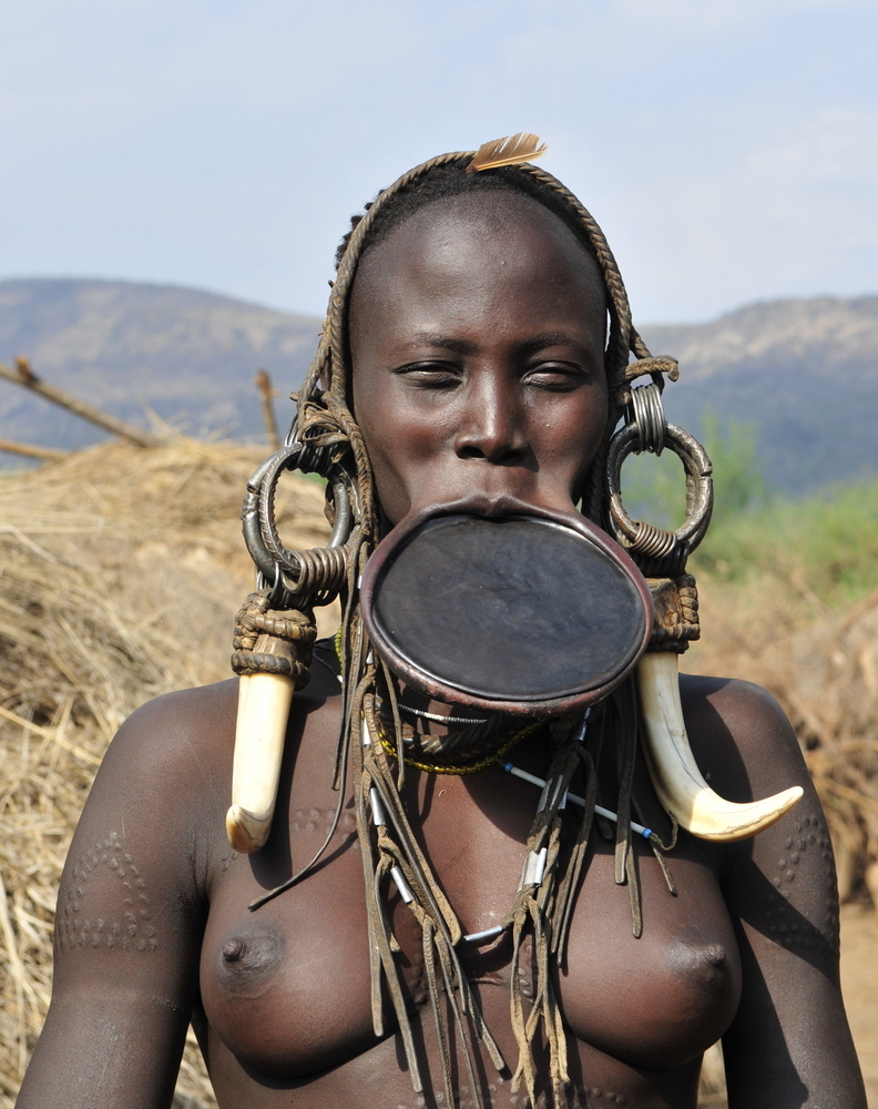 an African woman with a plate in her lip