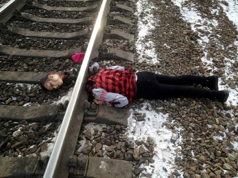 a girl lying dead after being decapitated by a train