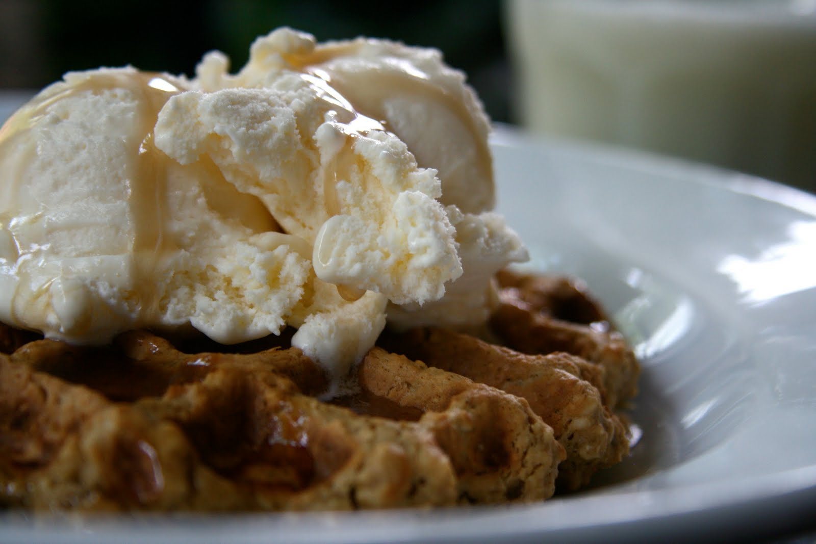 an oatmeal peanut butter waffle with ice cream and syrup