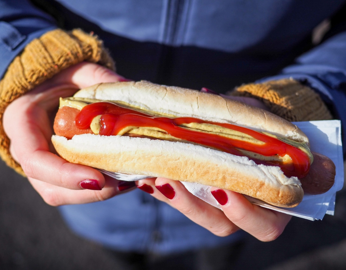 a hot dog with ketchup and mustard